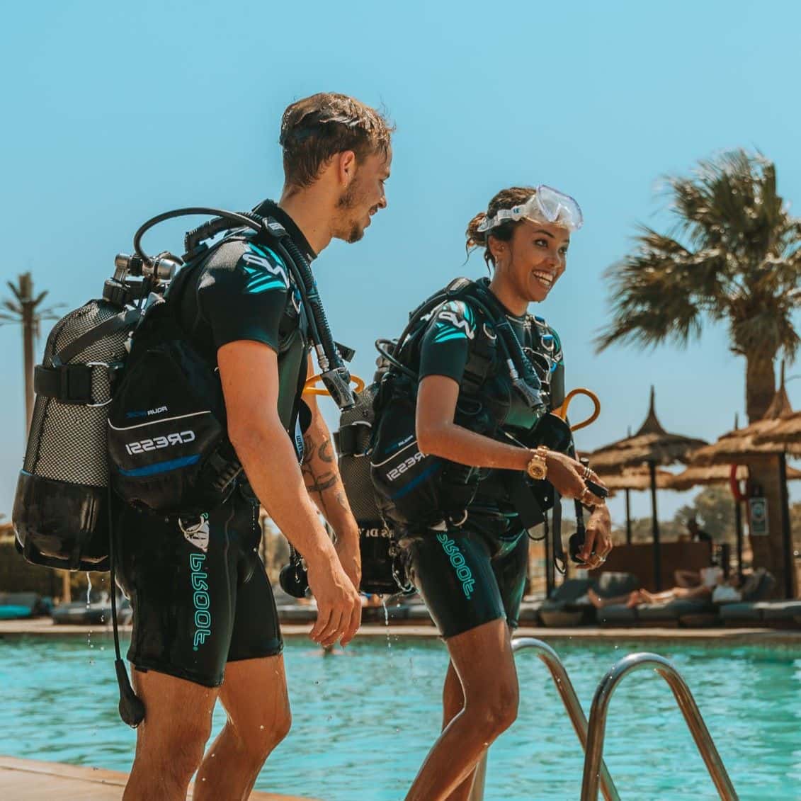 Two scuba divers preparing for pool training at the Blue Brothers dive center