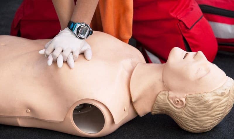 Participant practicing CPR on a training mannequin