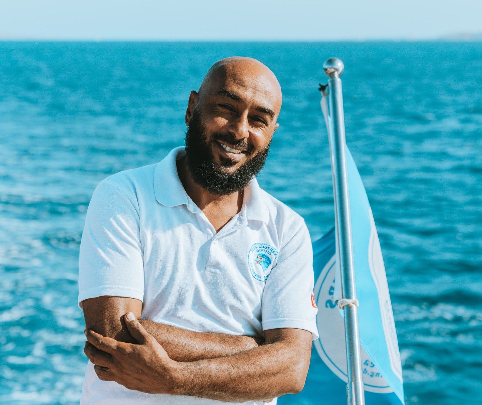 Mubarak from the Blue Brothers Diving team smiling on the boat