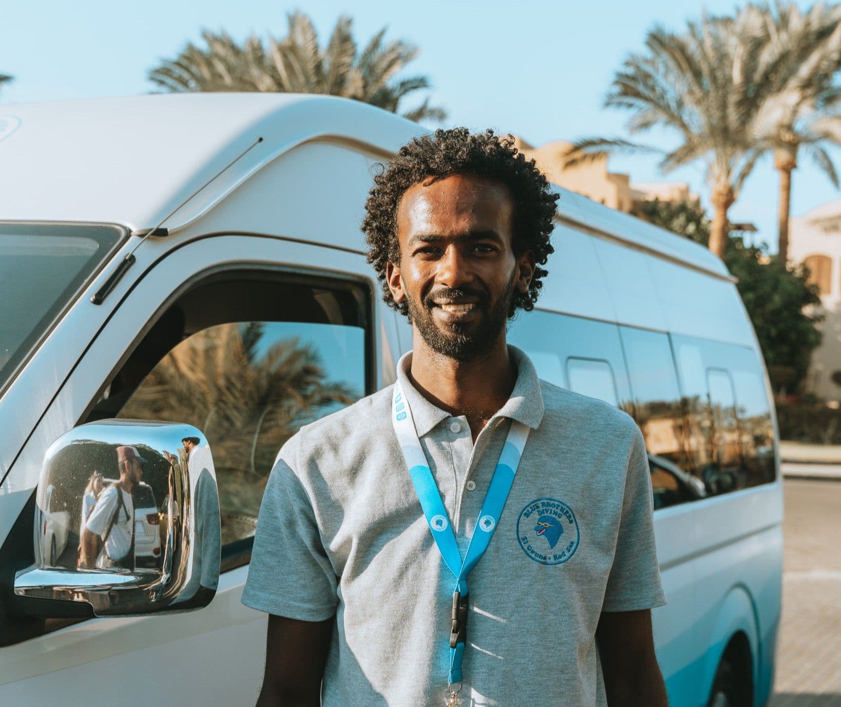Omar from the Blue Brothers Diving team standing by the transfer van
