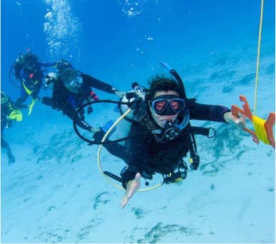 Drift divers swimming with a surface marker buoy in the Red Sea