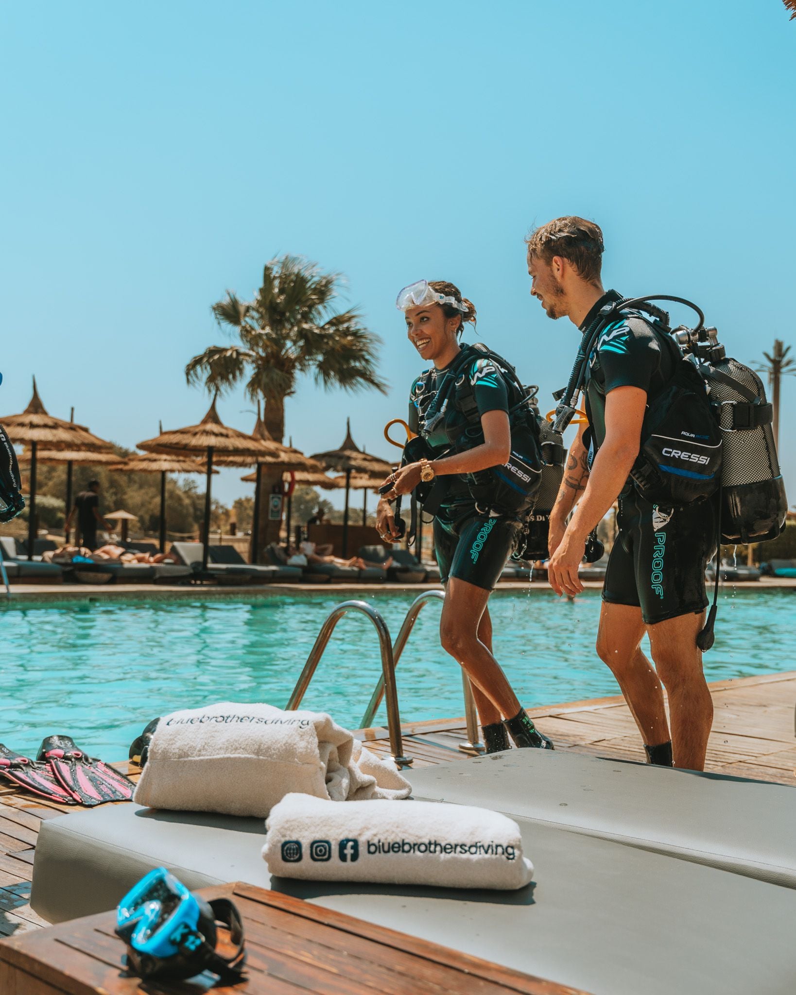 Open Water Diver students entering the training pool with scuba gear