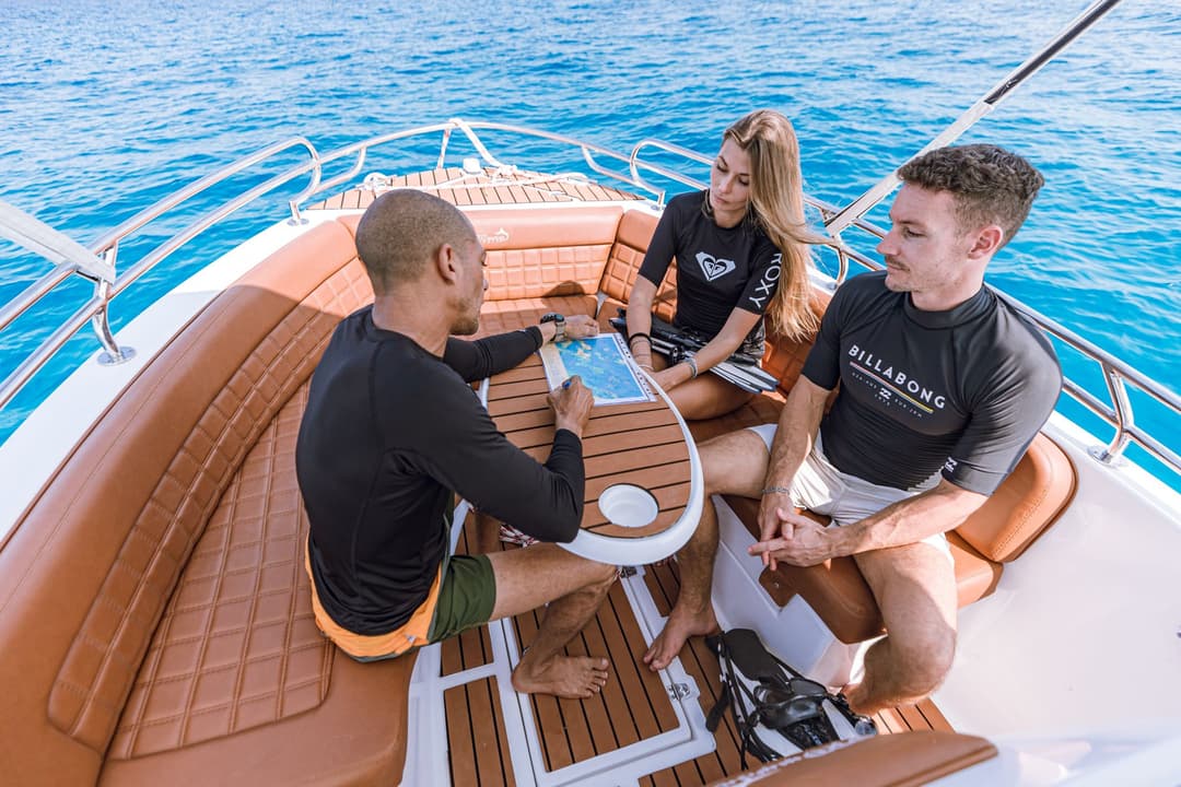 Guests relaxing around the table on a private speedboat trip