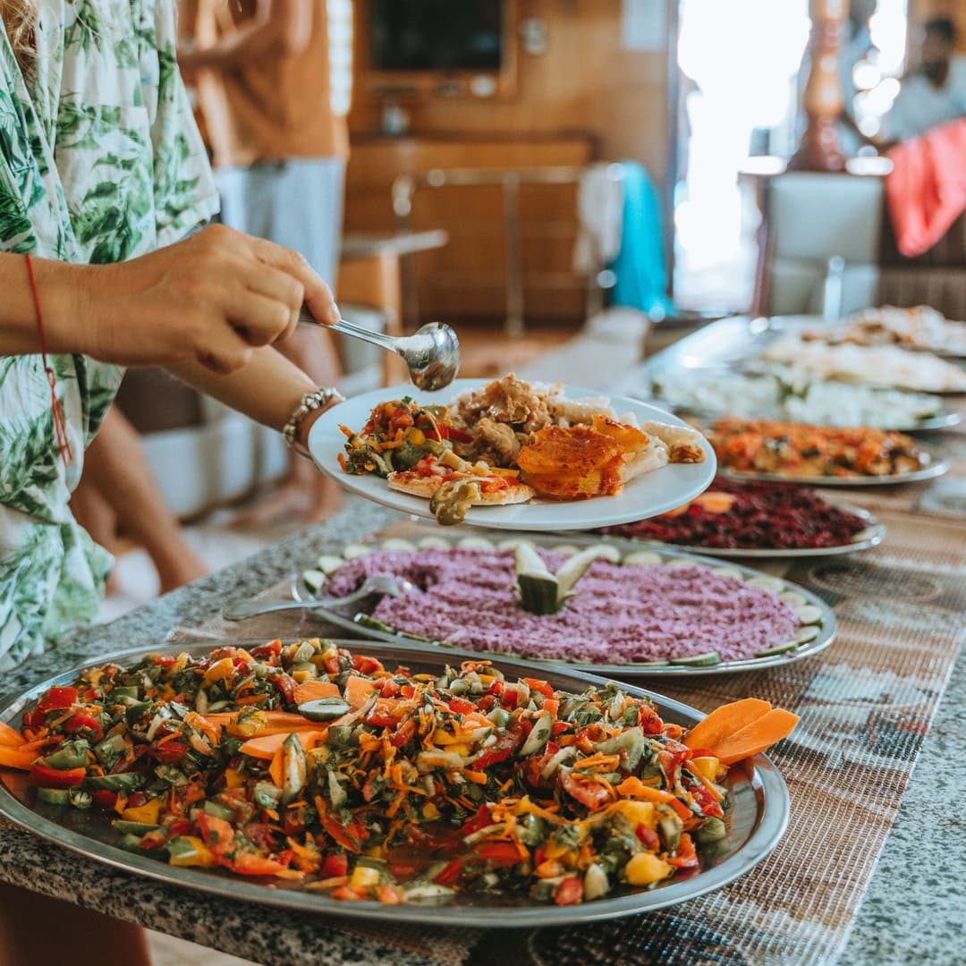 Guests choosing food from the boat buffet